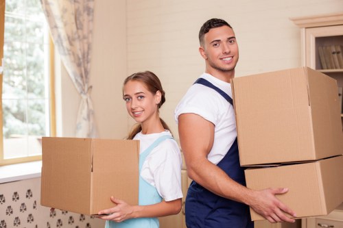 Moving team working safely with packing and transport equipment