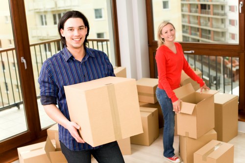 Professional office movers organizing desks and boxes for relocation