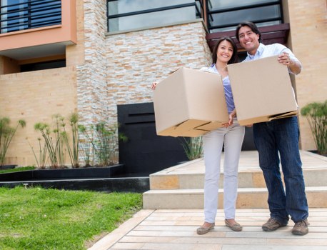 Removal professionals protecting floors and doorways during a move